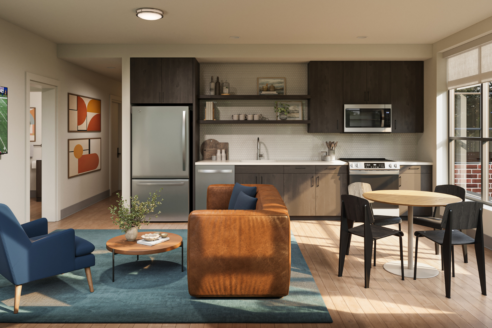 Interior Kitchen Open-concept apartment kitchen and living area with dark cabinetry, stainless steel appliances, dining space, and modern finishes.